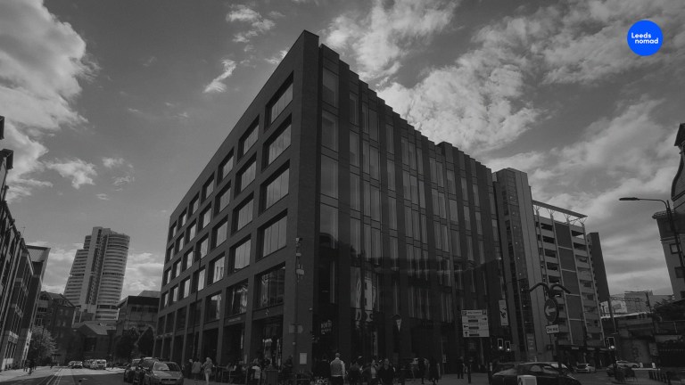 Black and white photo of the building that stands on the site of the Queen's Hall.