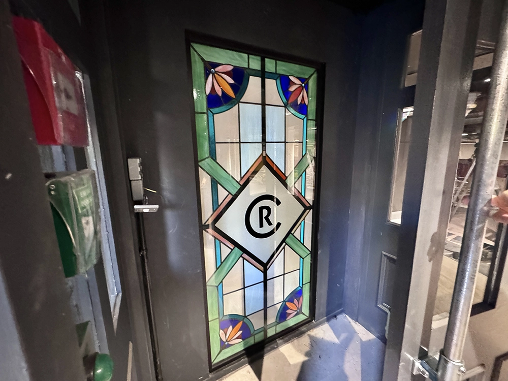 A stained glass window in a door.