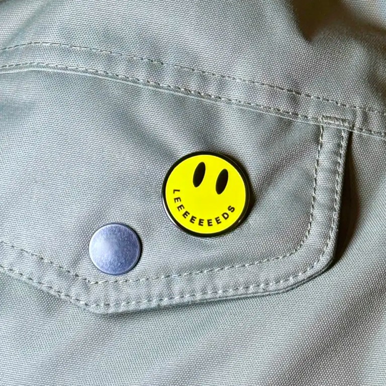 Acid House smiley badge with the word LEEEEEEEEEDS as its mouth.