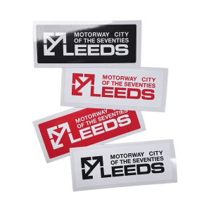 Four Leeds Motorway City window stickers in various red, white and black colourways.